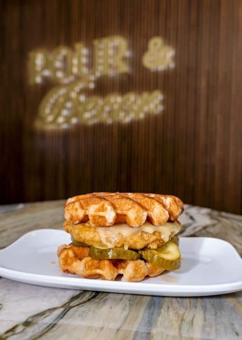 miss-b-chicken-waffle-sandwich-st-pete-scaled-rcmf1ed9inuqkc9z8yo0skfsutl8mowhq8b77ugswo A miss B's chicken and waffle sandwich food item at Pour and Decor coffee shop St Petersburg FL